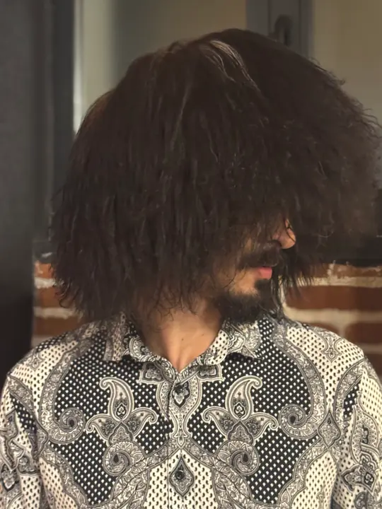 Black Sheepskin Papakha, three-quarter view: a wide crown of long, crinkled black wool