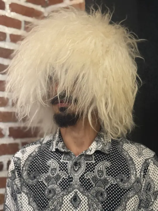 Very White Sheepskin Papakha, front view: long straight bright white wool falling over the face