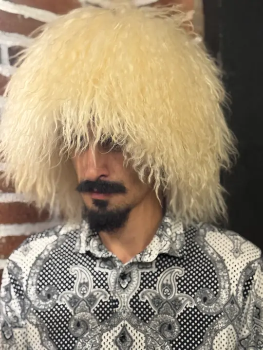 White Sheepskin Papakha, three-quarter view from the right: long cream-white wool with loose waves